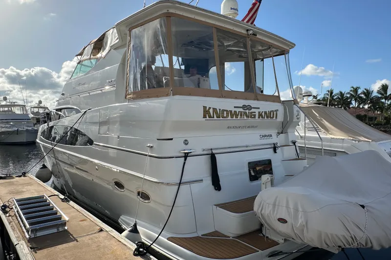 The Image of 2003 Carver 466 Motor Yacht docked, featuring "Knowing Knot" name on the stern. - 1