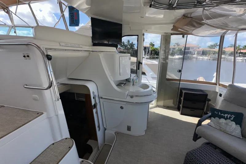 Slide: The Image of Interior of 2003 Carver 466 Motor Yacht with sink, seating, and marina view. - 74