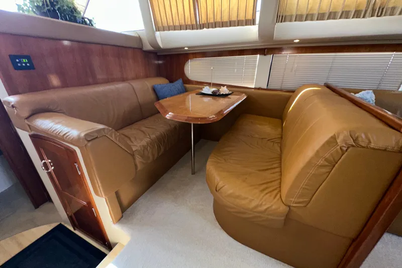 Slide: The Image of Interior of 2003 Carver 466 Motor Yacht with leather seating and wooden table. - 29