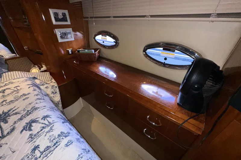 Slide: The Image of Interior of 2003 Carver 466 Motor Yacht with wooden cabinetry and porthole windows. - 43