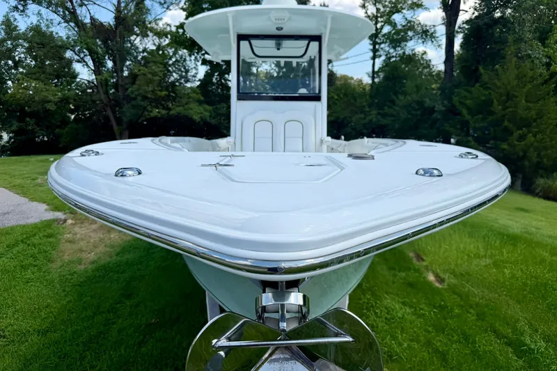 Slide: The Image of 2017 Sea Hunt Gamefish 30CB boat on grass, front view, surrounded by trees. - 20