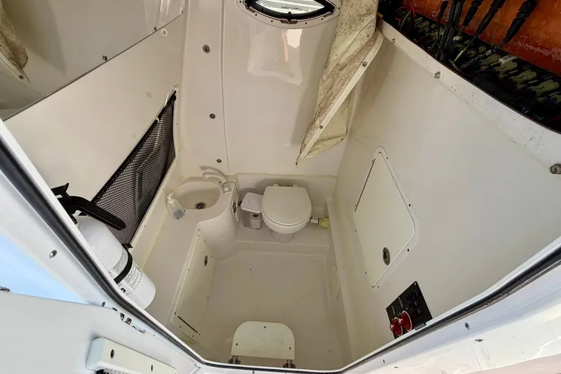 Slide: The Image of 2017 Sea Hunt Gamefish 30CB boat interior with toilet and sink. - 15