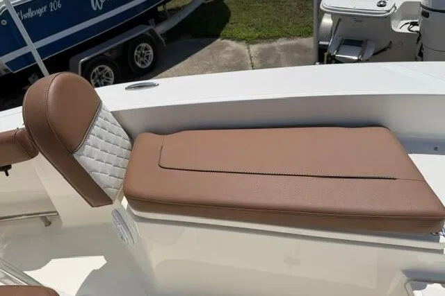 Slide: The Image of 2025 Pioneer 220 Bay Sport boat with brown cushioned seating. - 32
