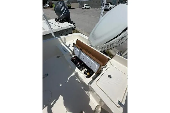 Slide: The Image of 2025 Pioneer 220 Bay Sport boat interior with open storage compartment and Yamaha engine. - 28