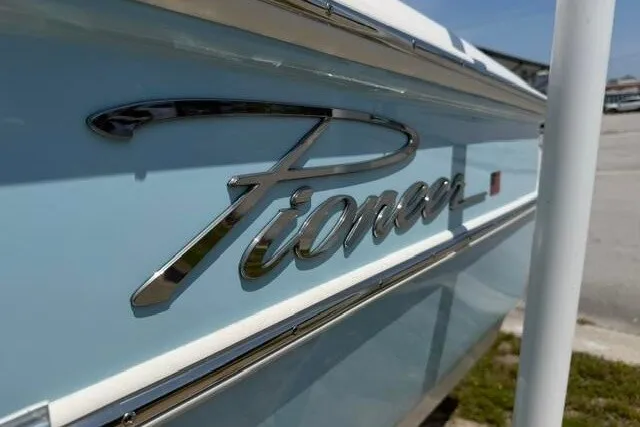 Slide: The Image of 2025 Pioneer 220 Bay Sport boat with sleek logo on light blue hull. - 10