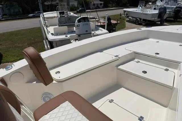 Slide: The Image of 2025 Pioneer 220 Bay Sport boat interior with brown seating and storage compartments. - 14