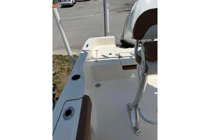 Slide: The Image of 2025 Pioneer 220 Bay Sport boat interior with seating and rod holders. - 21