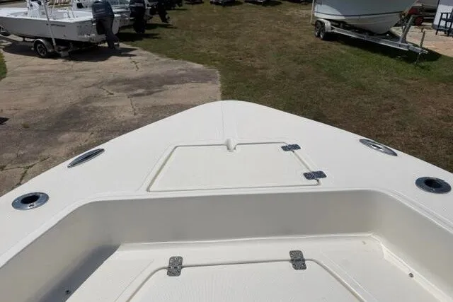 Slide: The Image of 2025 Pioneer 220 Bay Sport boat bow view, showcasing deck and hatch details. - 12