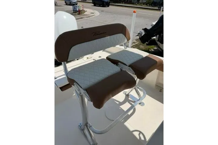 Slide: The Image of 2025 Pioneer 220 Bay Sport boat seating with brown and white cushioned design. - 23