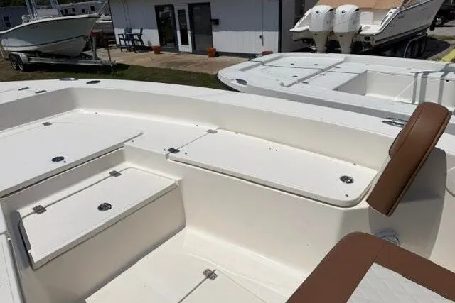 Slide: The Image of 2025 Pioneer 220 Bay Sport boat interior with seating and storage compartments. - 15