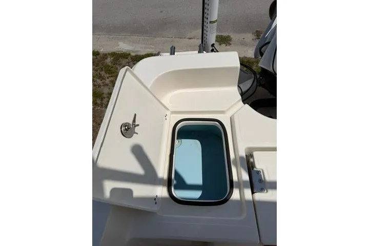 Slide: The Image of 2025 Pioneer 220 Bay Sport boat with open storage compartment and clean design. - 25