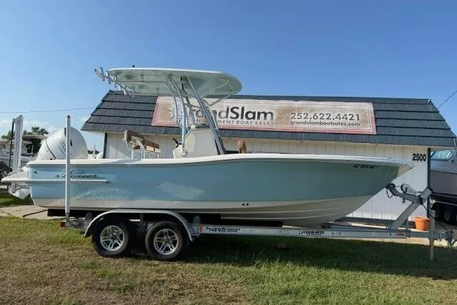 The Image of 2025 Pioneer 220 Bay Sport boat on trailer, displayed at Grand Slam Boat Sales. - 1