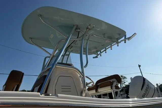 Slide: The Image of 2025 Pioneer 220 Bay Sport boat with T-top and Suzuki outboard motor. - 6