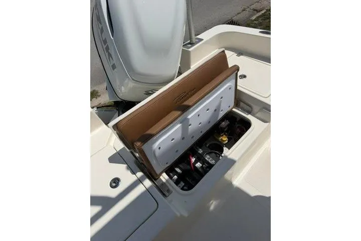 Slide: The Image of 2025 Pioneer 220 Bay Sport boat with open storage compartment and visible engine components. - 38