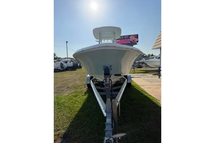 Slide: The Image of 2025 Pioneer 220 Bay Sport boat on trailer under bright sun. - 4