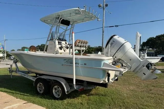 Slide: The Image of 2025 Pioneer 220 Bay Sport boat on trailer, featuring a sleek design and powerful outboard motor. - 8