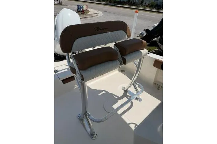Slide: The Image of 2025 Pioneer 220 Bay Sport boat seat with brown and white cushioned design. - 22