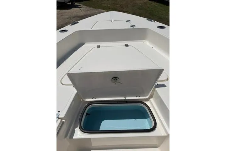 Slide: The Image of 2025 Pioneer 220 Bay Sport boat with open storage compartment on deck. - 13