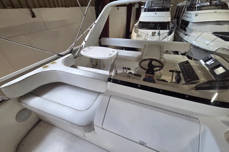 Slide: The Image of 1997 Sea Ray 440 Express Bridge interior with helm, seating, and control panel. - 10