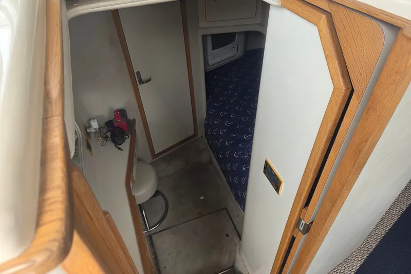 Slide: The Image of Interior view of 1997 Sea Ray 440 Express Bridge cabin with wooden accents and nautical decor. - 23
