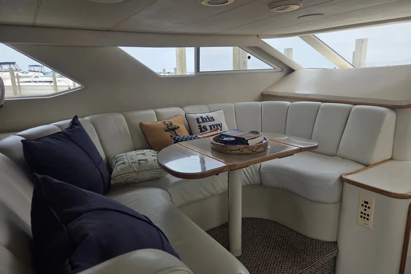 Slide: The Image of Luxurious interior of a 1997 Sea Ray 440 Express Bridge yacht with plush seating. - 17