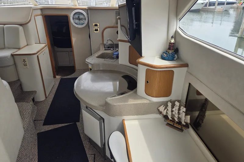 Slide: The Image of Interior of 1997 Sea Ray 440 Express Bridge yacht with modern amenities. - 16