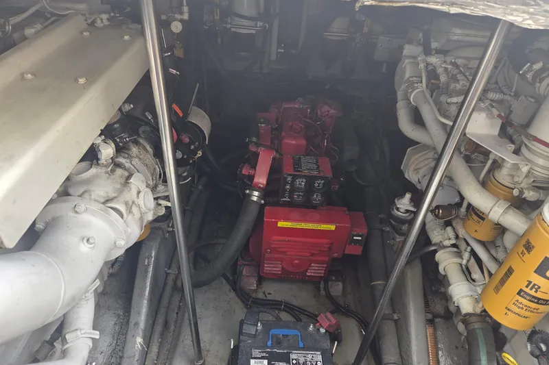 Slide: The Image of Engine room of a 1997 Sea Ray 440 Express Bridge with visible components and wiring. - 32