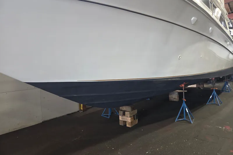 Slide: The Image of 1997 Sea Ray 440 Express Bridge yacht on stands in a maintenance facility. - 33