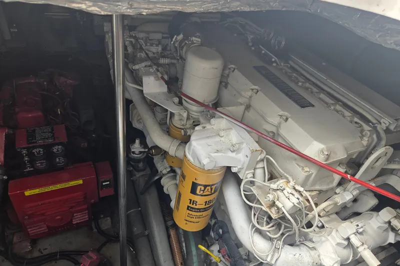 Slide: The Image of Engine compartment of a 1997 Sea Ray 440 Express Bridge with visible machinery and components. - 29
