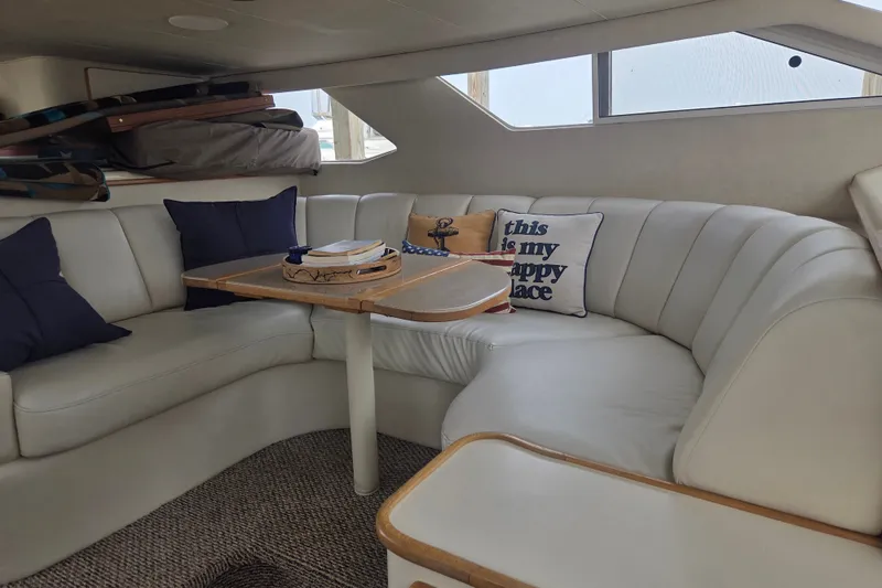 Slide: The Image of Interior of 1997 Sea Ray 440 Express Bridge with cozy seating and nautical decor. - 18