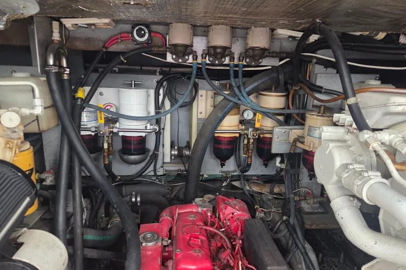Slide: The Image of Engine room of a 1997 Sea Ray 440 Express Bridge with visible components and hoses. - 31