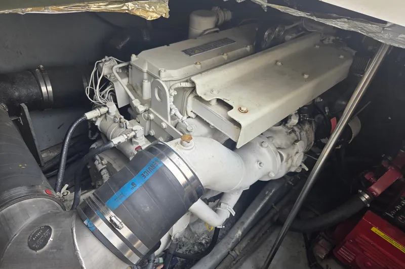 Slide: The Image of Engine compartment of a 1997 Sea Ray 440 Express Bridge boat, showcasing mechanical components. - 30