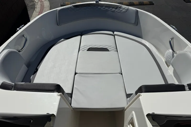 Slide: The Image of 2023 Bayliner Element M17 boat interior with cushioned seating and sleek design. - 11