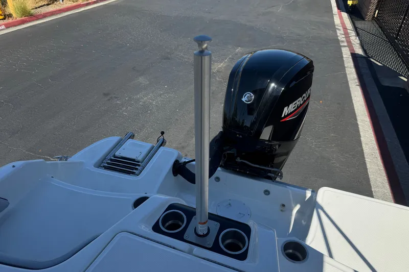 Slide: The Image of 2023 Bayliner Element M17 boat with Mercury outboard motor, docked on pavement. - 20