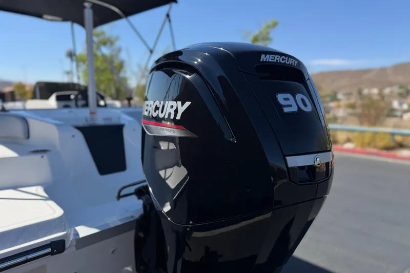Slide: The Image of 2023 Bayliner Element M17 with Mercury 90 outboard motor, parked outdoors. - 7