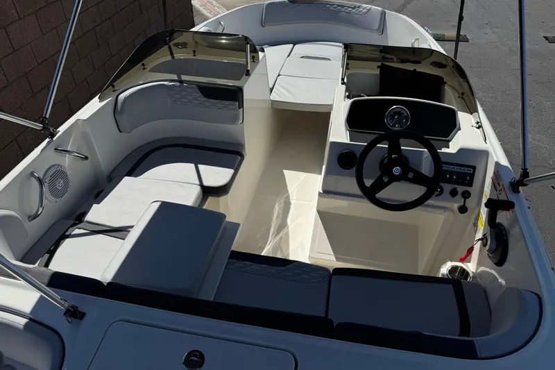 Slide: The Image of 2023 Bayliner Element M17 boat interior with steering wheel and seating arrangement. - 9