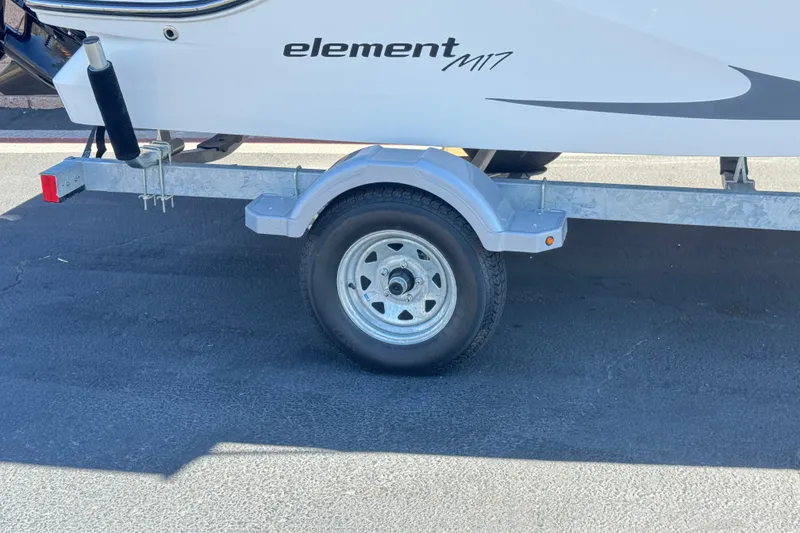 Slide: The Image of 2023 Bayliner Element M17 boat on trailer, close-up of wheel and hull. - 26