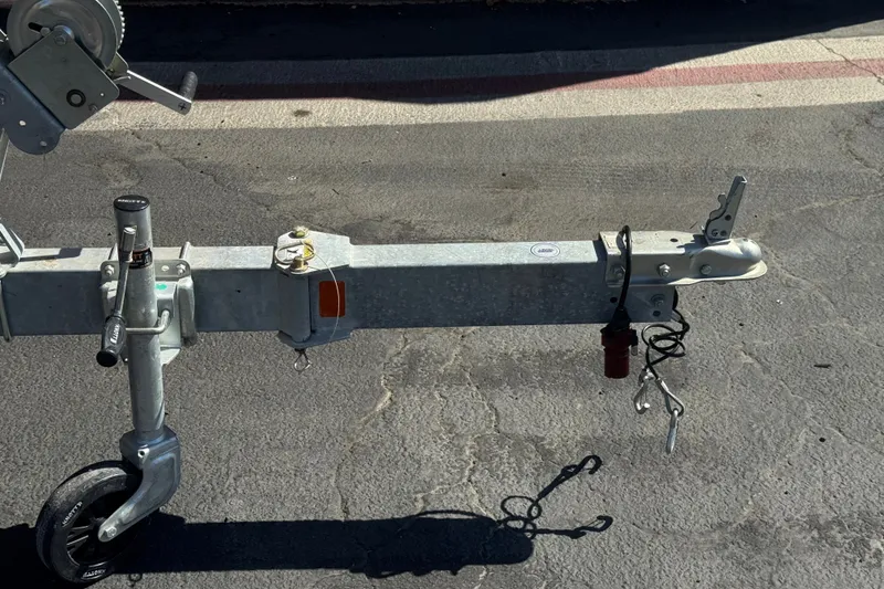 Slide: The Image of Trailer hitch for 2023 Bayliner Element M17 boat on asphalt surface. - 27
