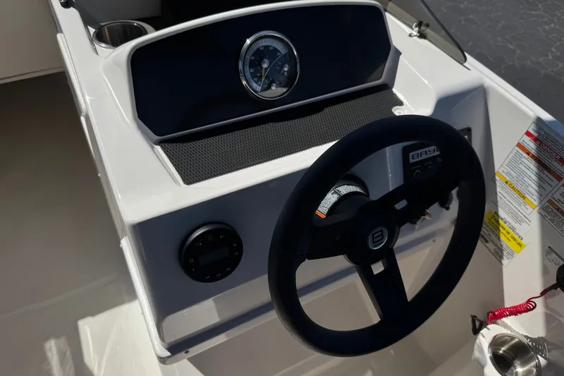 Slide: The Image of 2023 Bayliner Element M17 dashboard with steering wheel and gauges. - 25