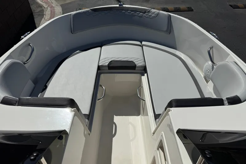 Slide: The Image of 2023 Bayliner Element M17 boat interior with cushioned seating and sleek design. - 12