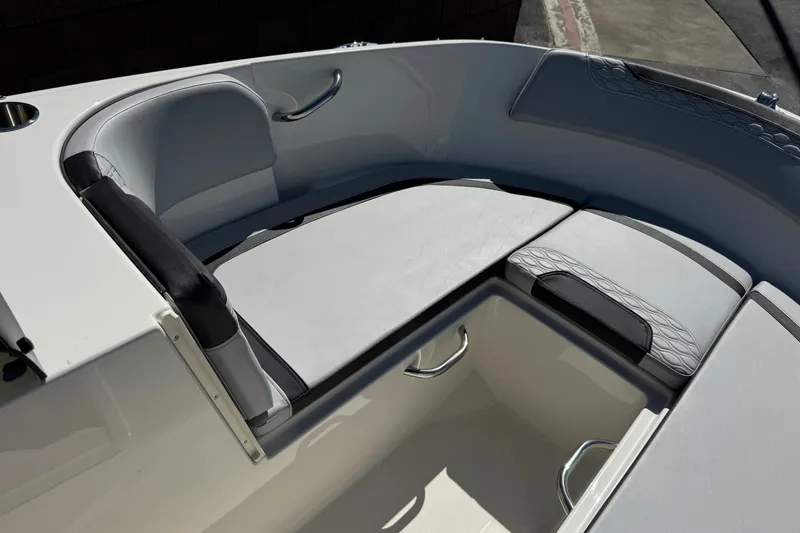 Slide: The Image of 2023 Bayliner Element M17 boat interior with cushioned seating and storage area. - 13
