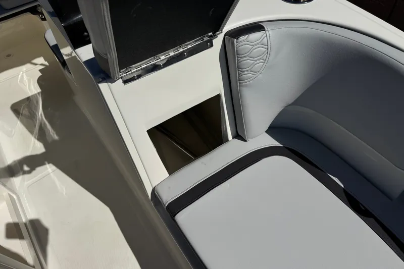 Slide: The Image of 2023 Bayliner Element M17 boat interior with open storage compartment and cushioned seating. - 15