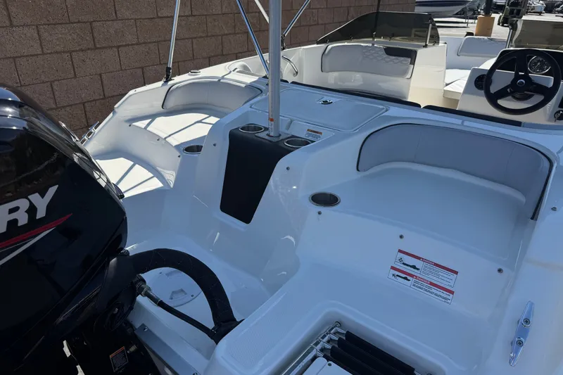 Slide: The Image of 2023 Bayliner Element M17 boat interior with seating and Mercury engine. - 8
