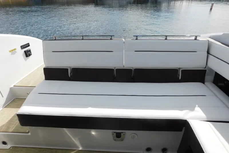 Slide: The Image of 2019 Cobalt A36BR boat with white cushioned seating by the water. - 33