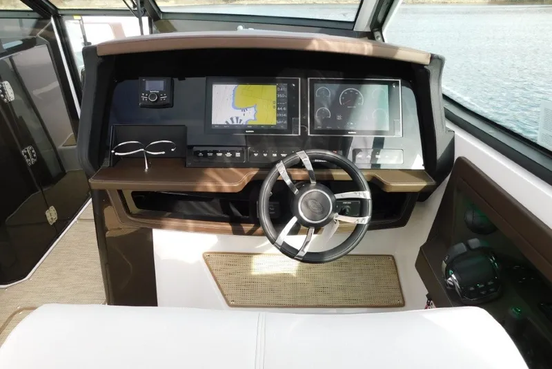 Slide: The Image of 2019 Cobalt A36BR boat dashboard with navigation screens and steering wheel. - 17