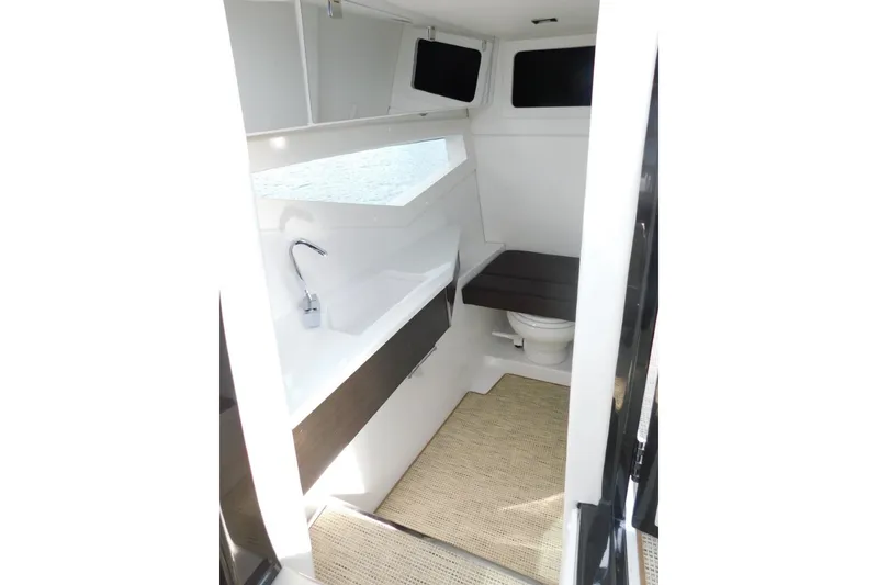 Slide: The Image of Interior of 2019 Cobalt A36BR boat featuring a compact bathroom with sink and toilet. - 21