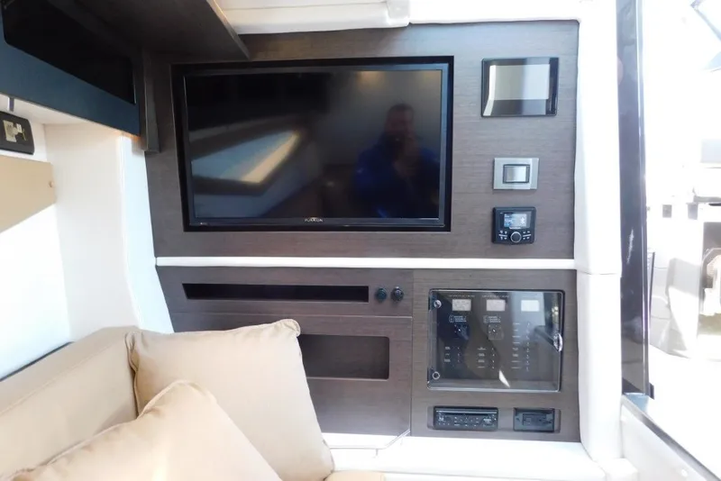 Slide: The Image of Interior of 2019 Cobalt A36BR boat featuring a modern entertainment system and control panel. - 25