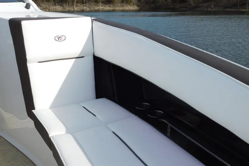 Slide: The Image of Luxurious seating on a 2019 Cobalt A36BR boat, featuring white upholstery and cup holders. - 27