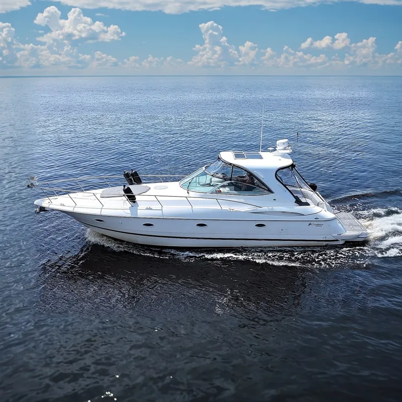The Image of 2003 Cruisers Yachts 3970 Express cruising on calm waters. - 0