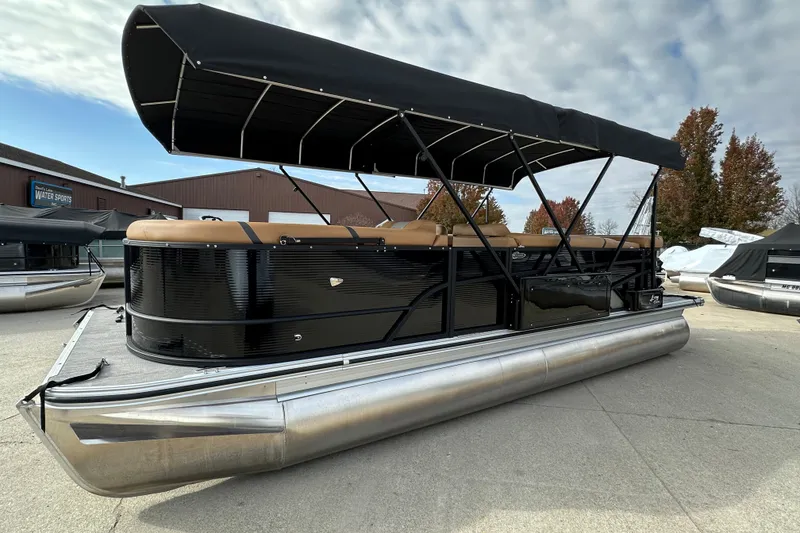 The Image of 2025 Crest Classic 220 pontoon boat with black canopy and sleek design. - 0
